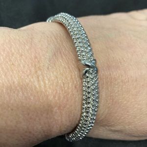 Silver Beveled Bangle bracelet with an Iconic Knot Parklane